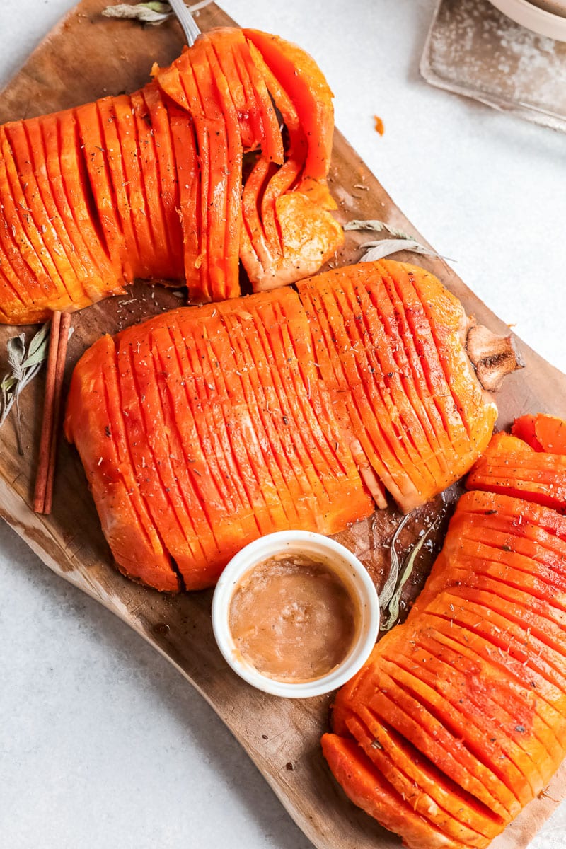 top view of hasselback butternut squash stacked on wooden board