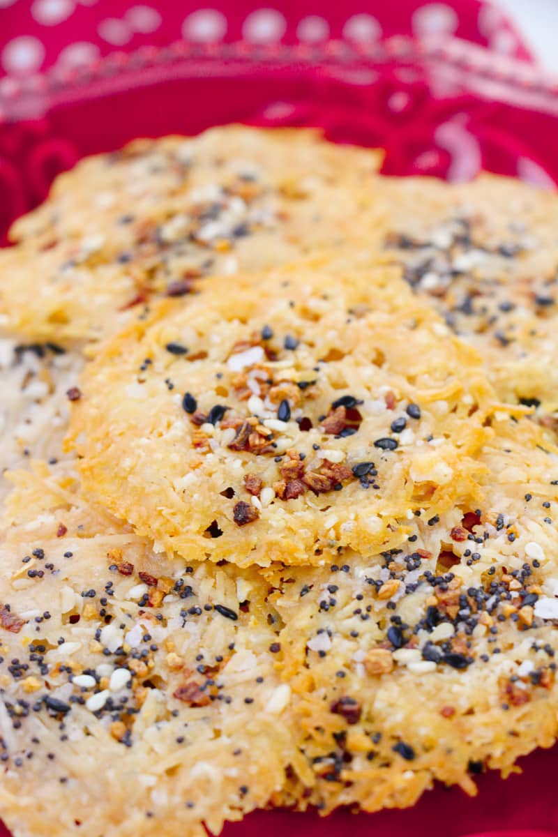 close up stack of easy parmesan crisps on red plate