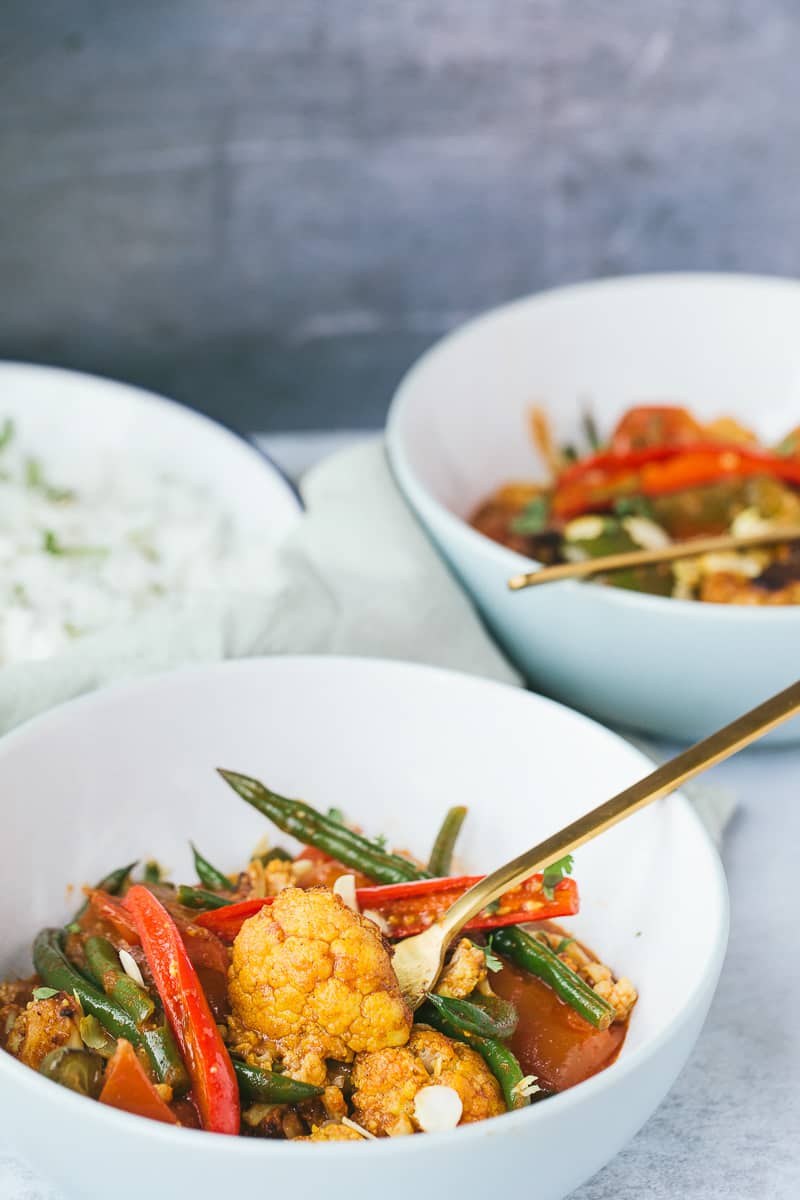 vegetable curry being served in a white bowl