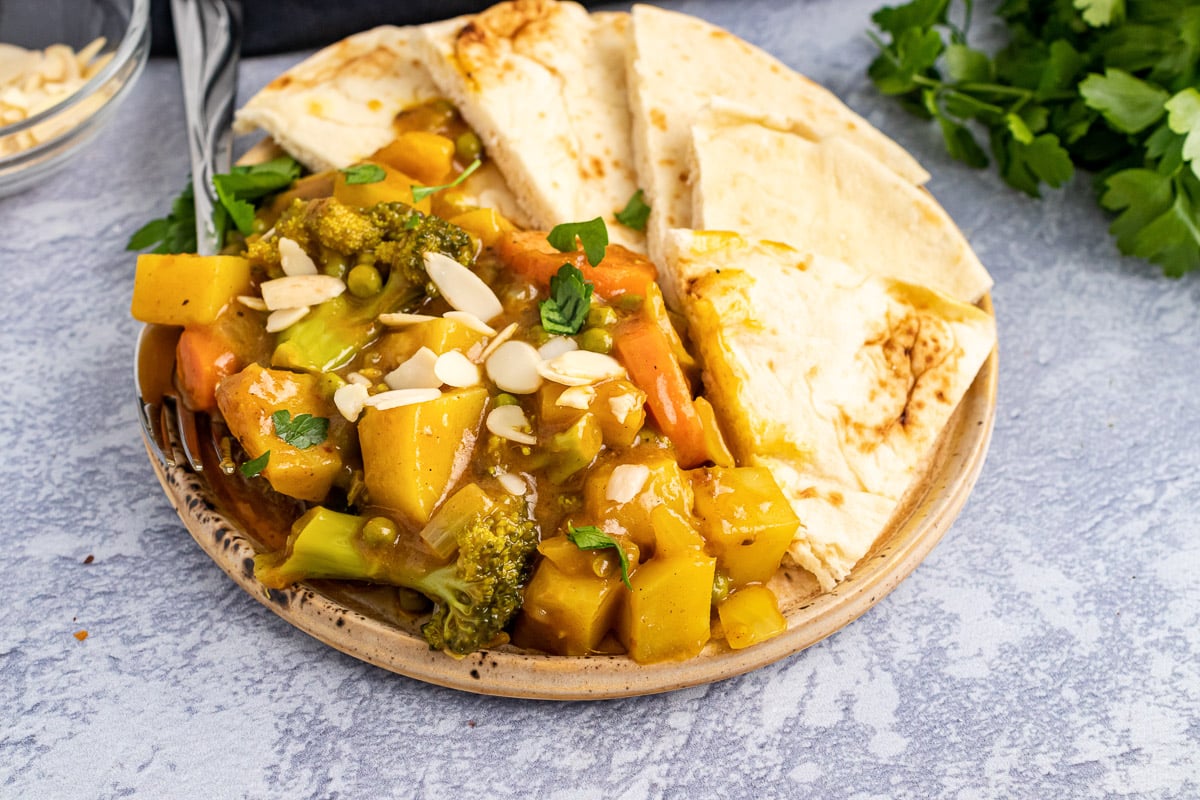 plate of 30-minute vegetable korma with naan bread slices