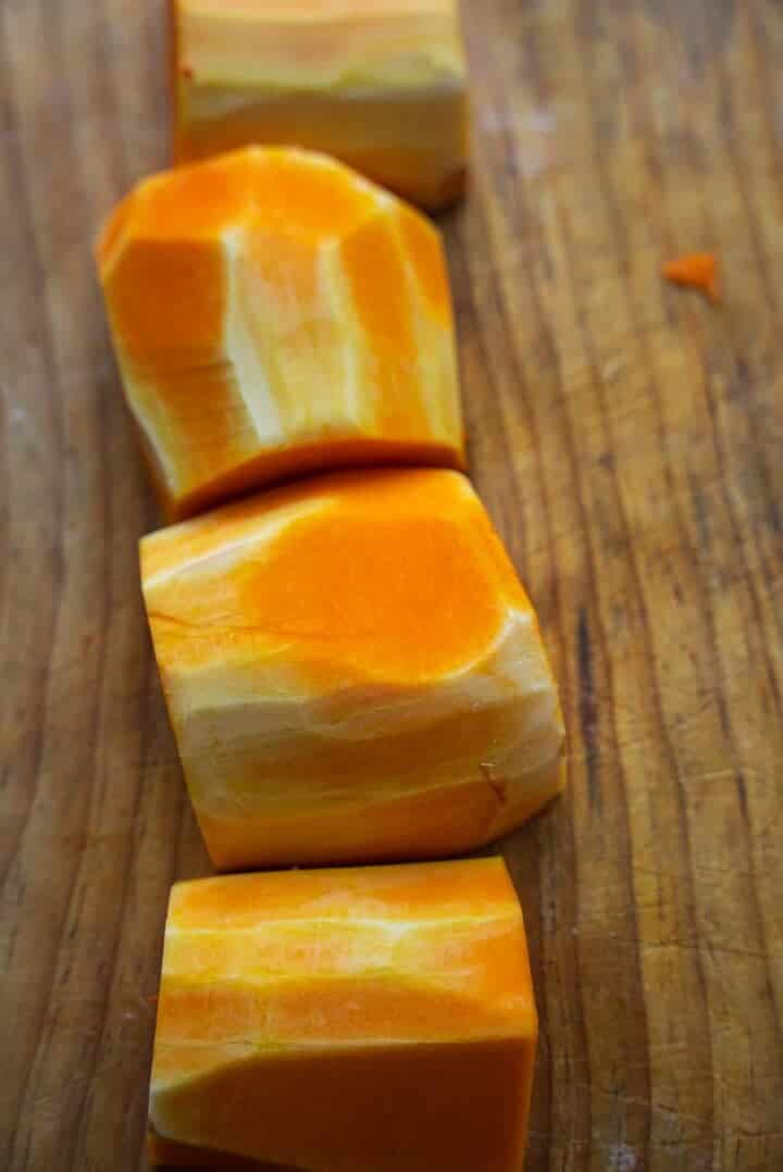 Butternut squash pieces on a board