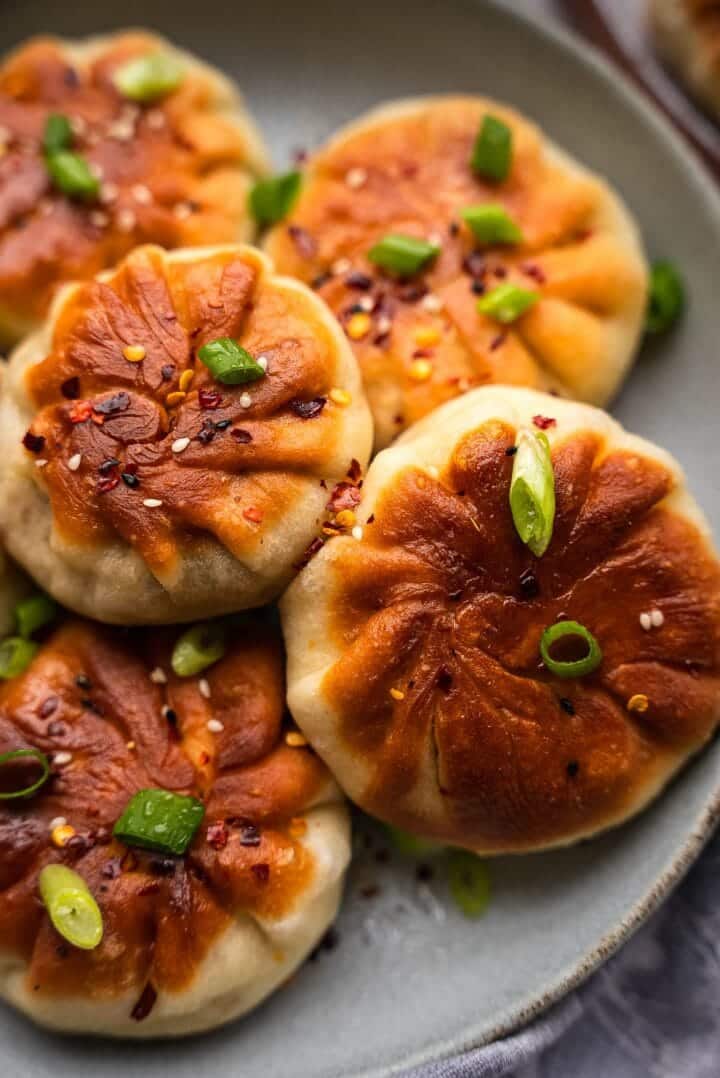 Crispy tofu buns with scallions on a plate