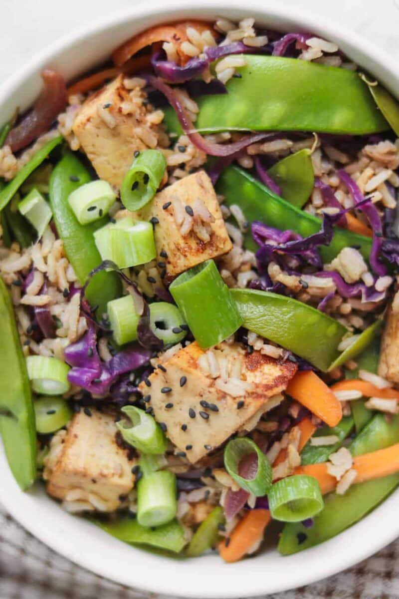 Almond tofu and vegetable rice stir-fry with green peas 