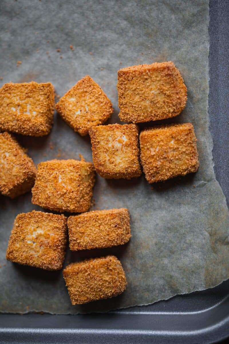 Baked tofu cubes on a baking tray
