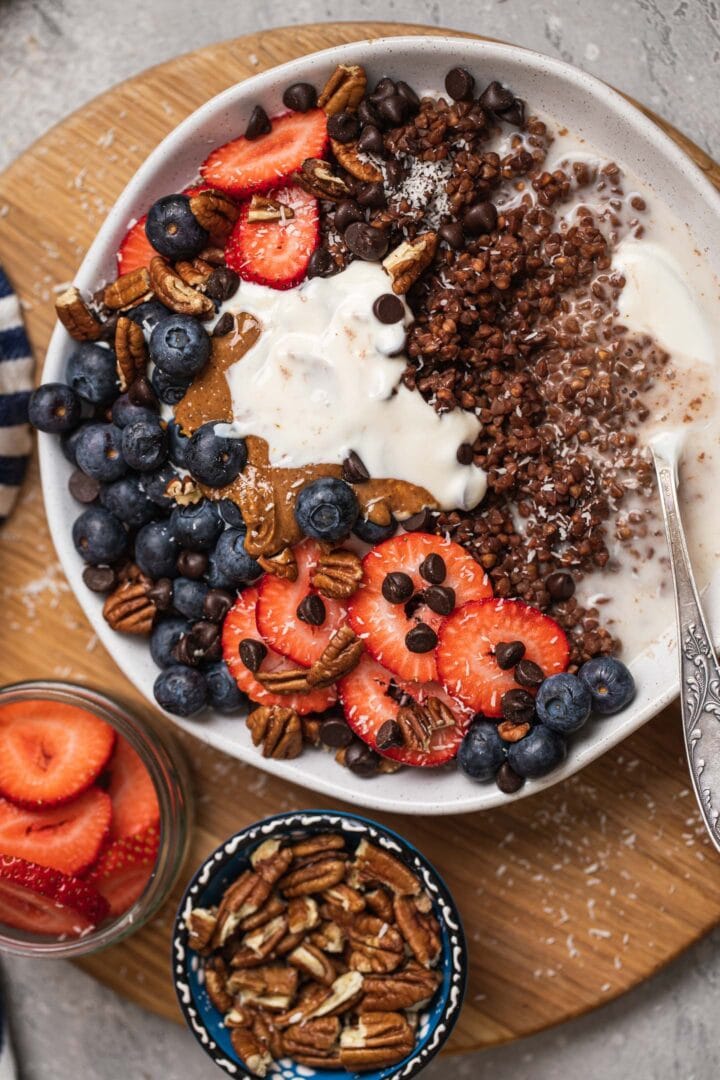 Bowl of buckwheat with vegan yoghurt, peanut butter and berries
