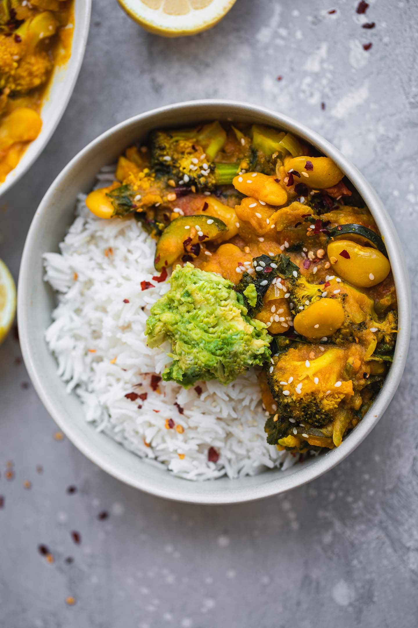 Bowl of butter bean stew with avocado and rice