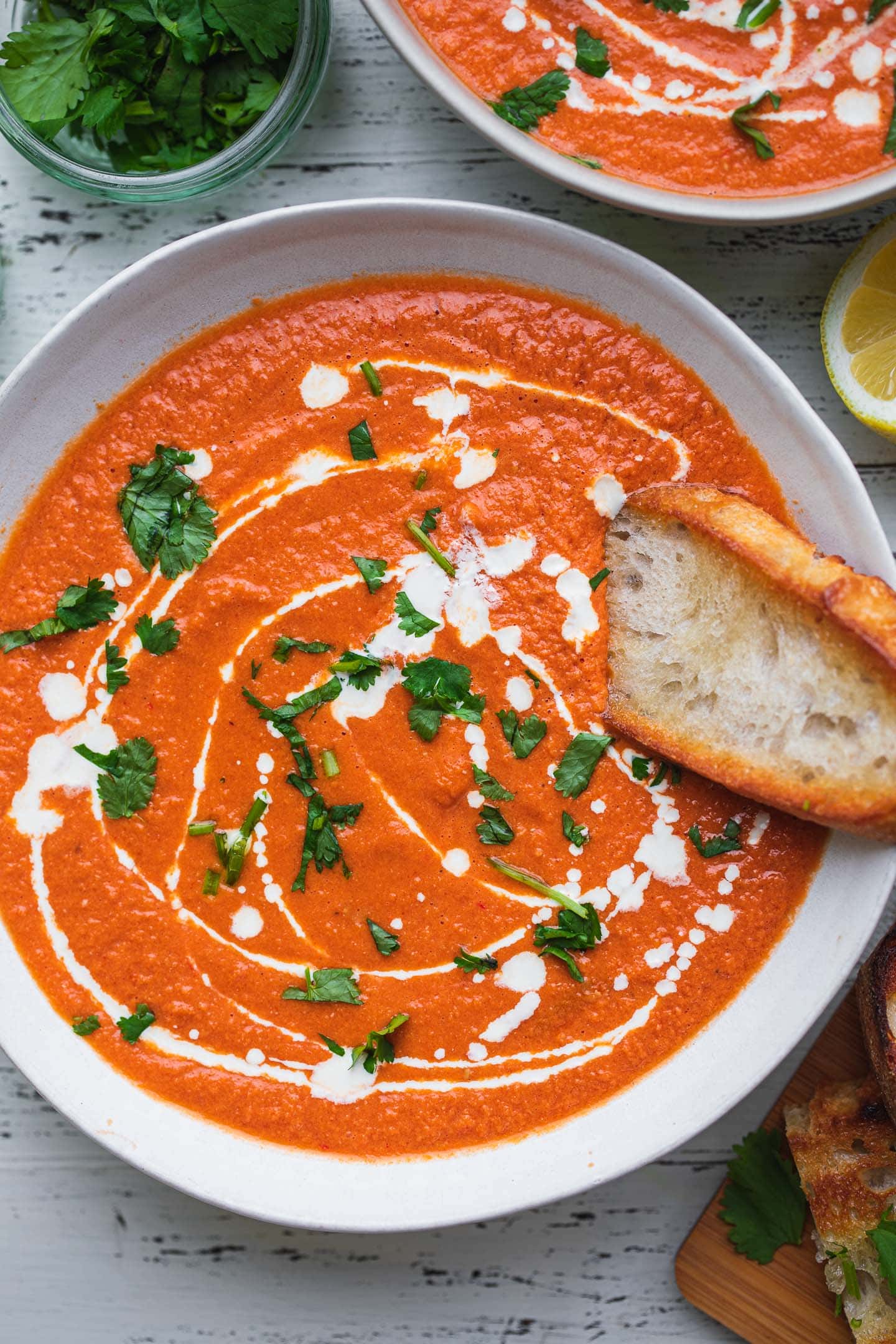 Bowl of dairy-free tomato bisque with crusty bread