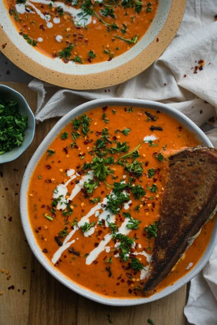 Bowl of dairy-free tomato soup with grilled cheese