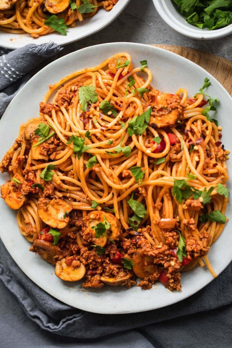 Bowl of plant based spaghetti Bolognese with vegetables in a bowl