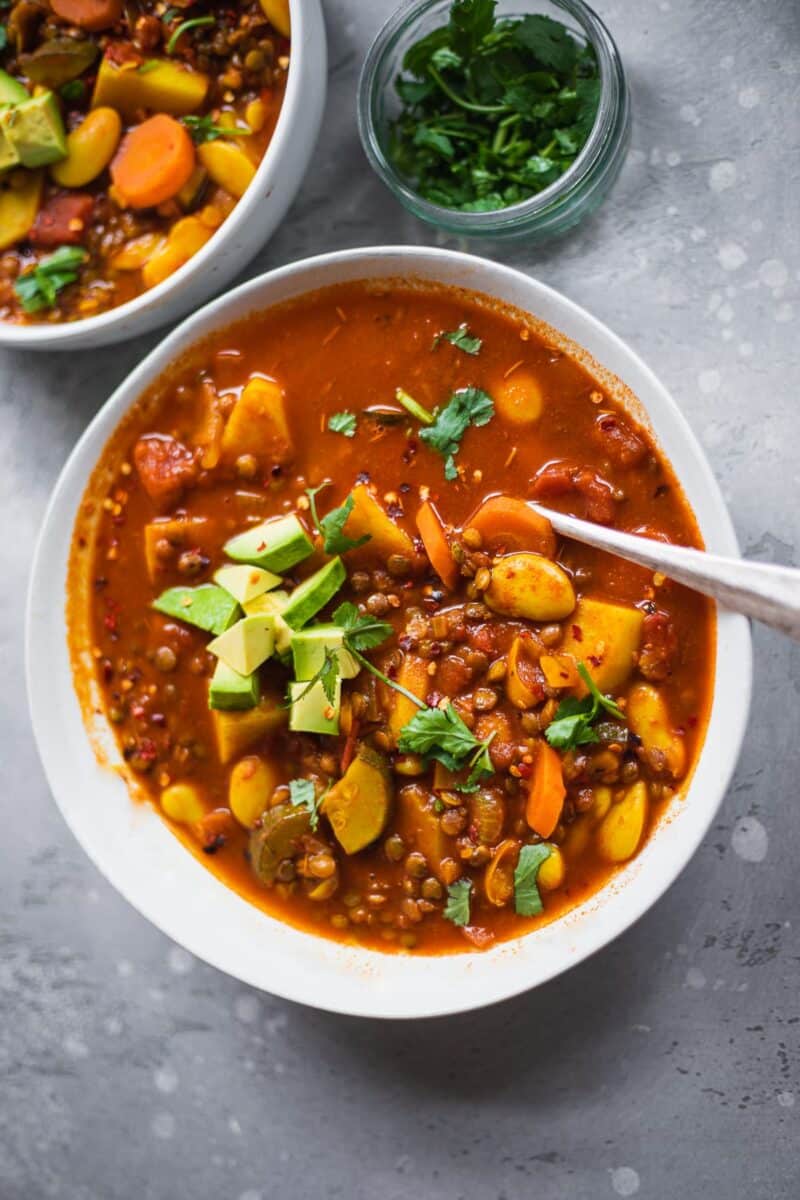 Bowl of vegan lentil soup with avocado