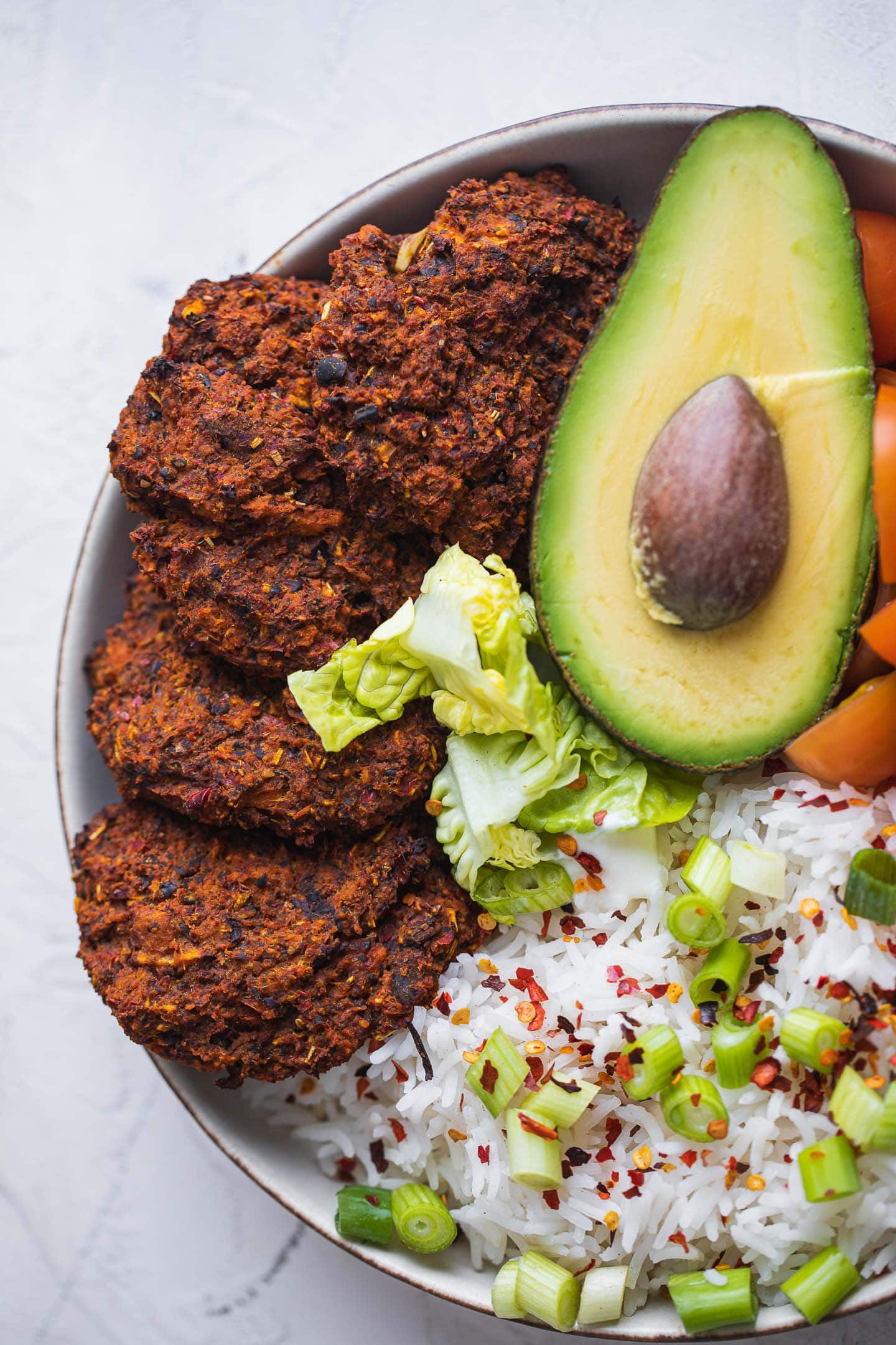 Bowl with black bean burgers, rice and avocado