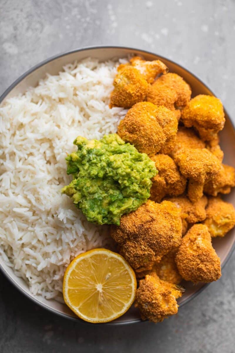 Bowl with breaded cauliflower, rice and avocado