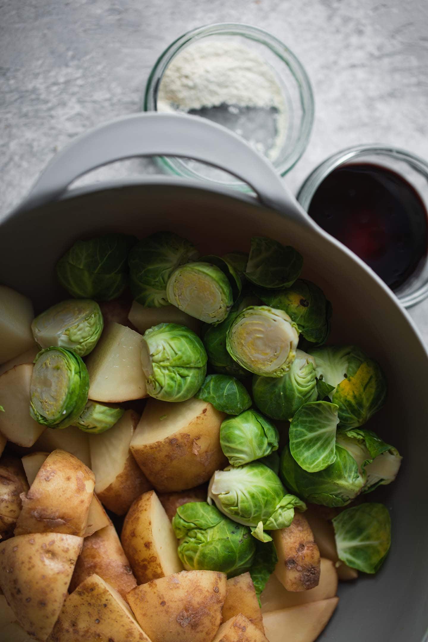 Brussels sprouts and potatoes in a mixing bowl