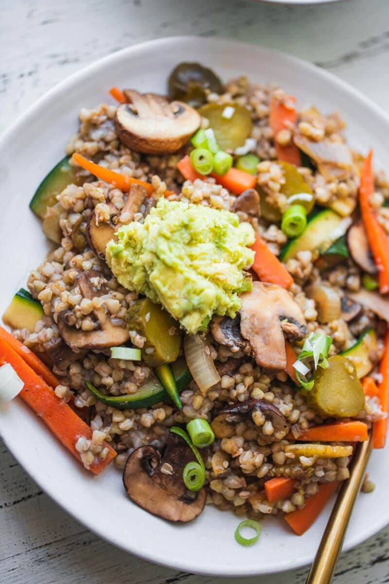 Buckwheat with vegetables and avocado sauce in a bowl