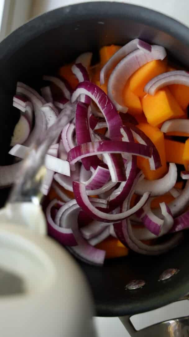 Butternut squash and onion in a saucepan