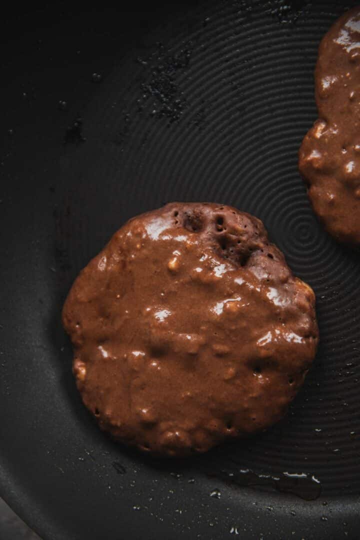 Cacao pancakes on a frying pan