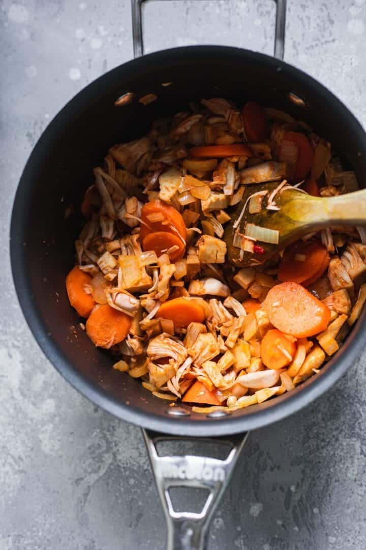 Carrots, jackfruit and spices in a saucepan