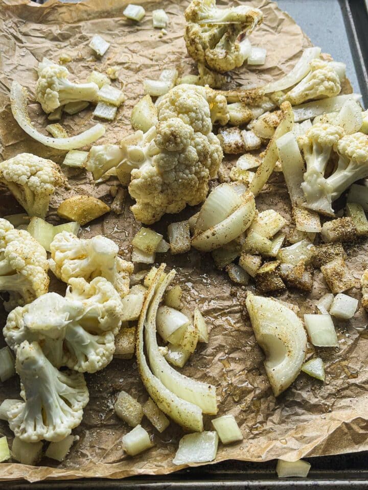 Cauliflower, onion and garlic on a baking tray