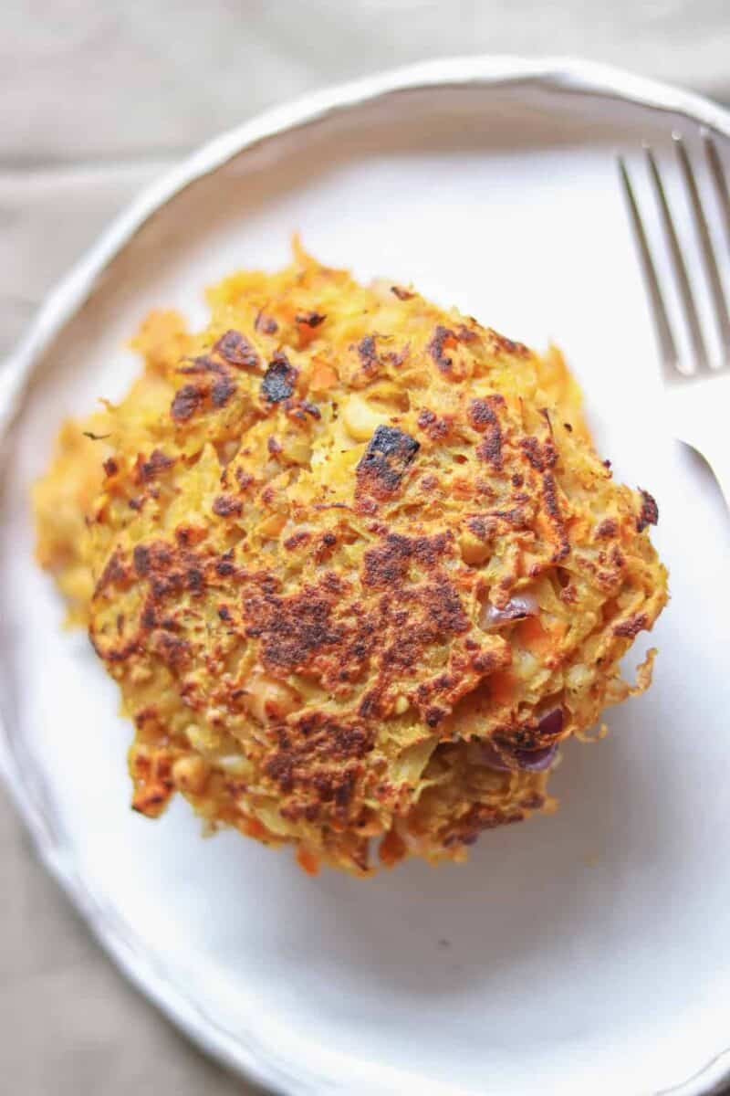 Vegan chickpea potato fritters resting on a plate 