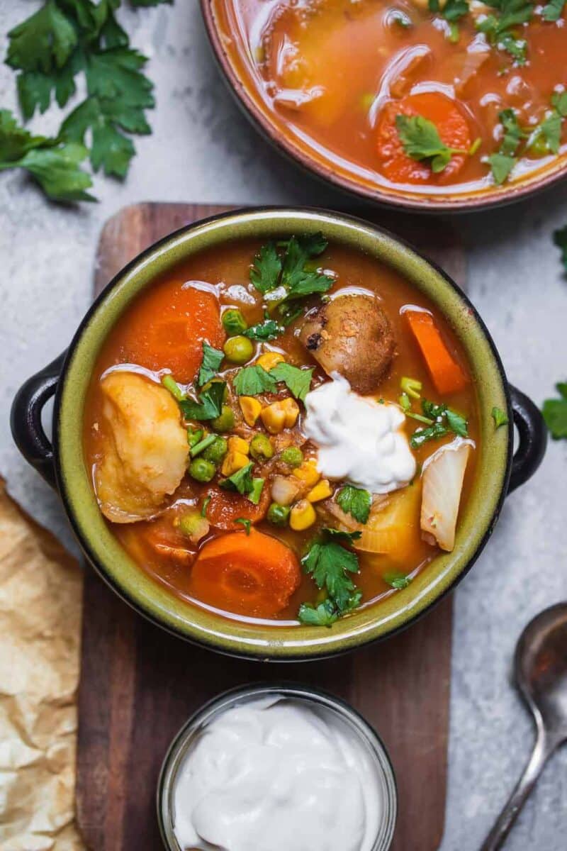 Vegan potato soup with peas carrots and sweetcorn