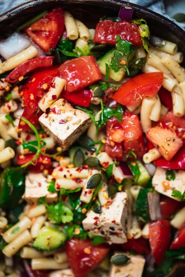 Closeup of a vegan pasta salad with tofu feta