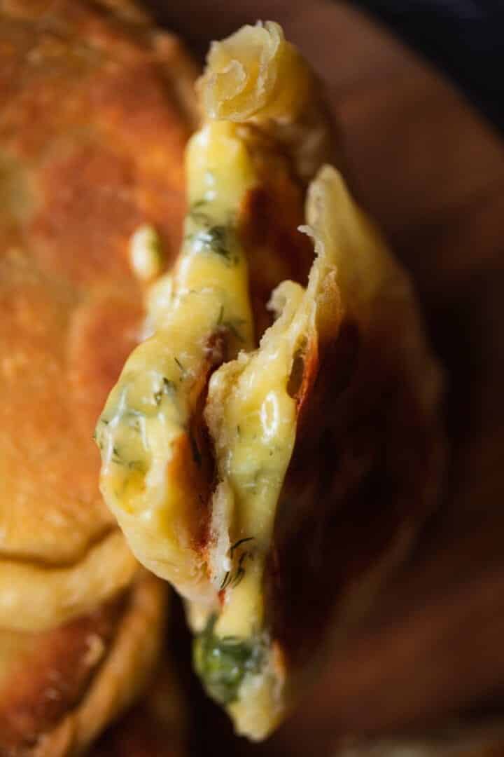 Closeup of a vegan pirozhok with cheese