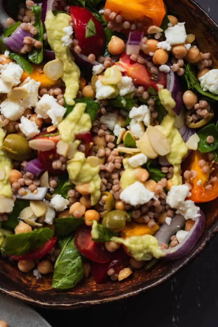 Closeup of couscous salad with avocado dressing