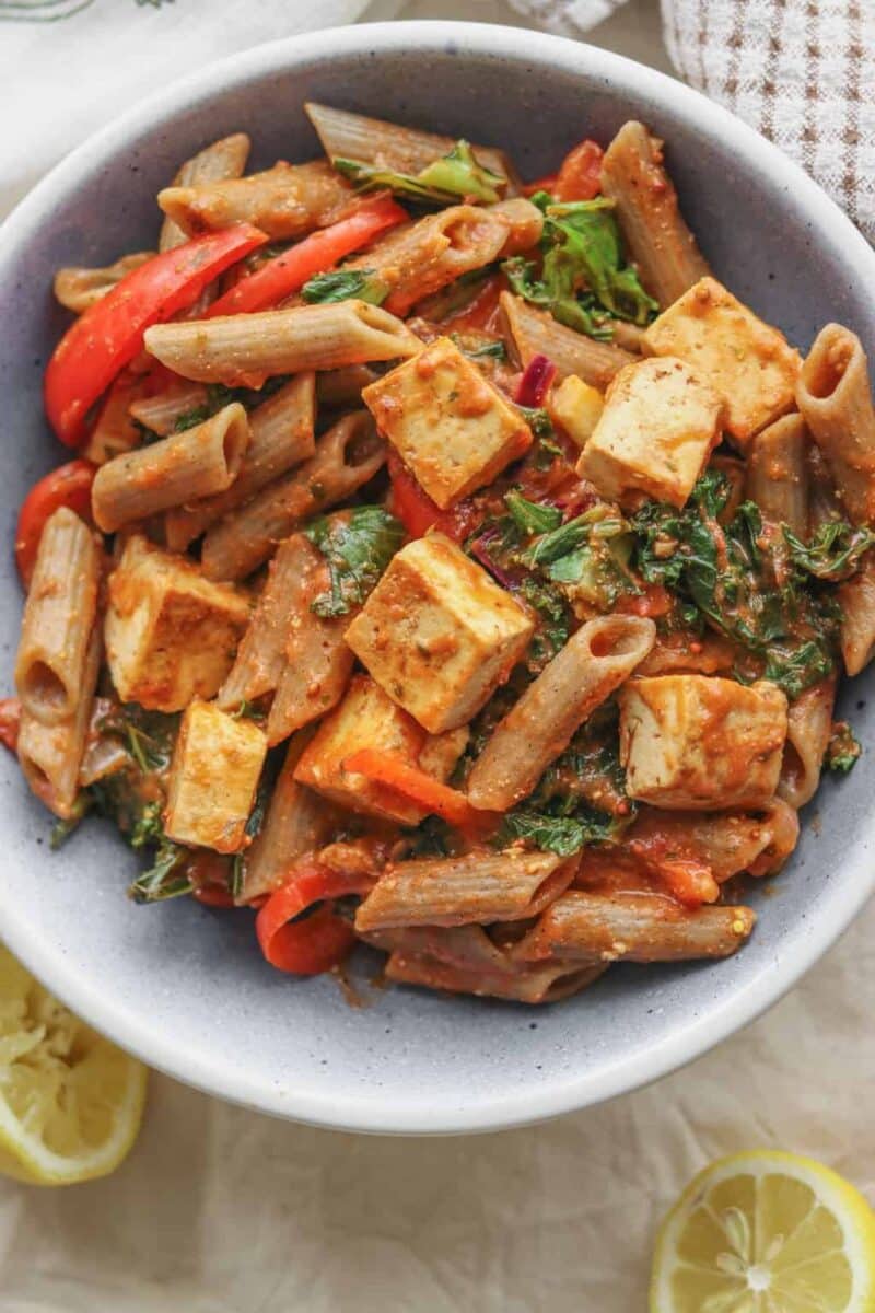 Healthy vegan tomato sauce pasta with tofu and red pepper