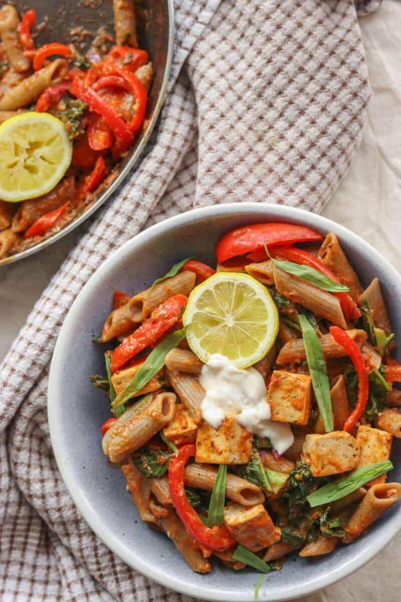 Bowl of creamy vegan tomato pasta with tofu