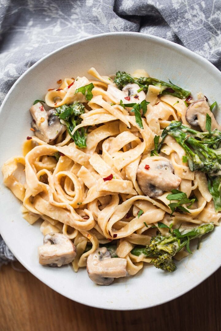 Fettuccini in a bowl with broccoli and mushrooms