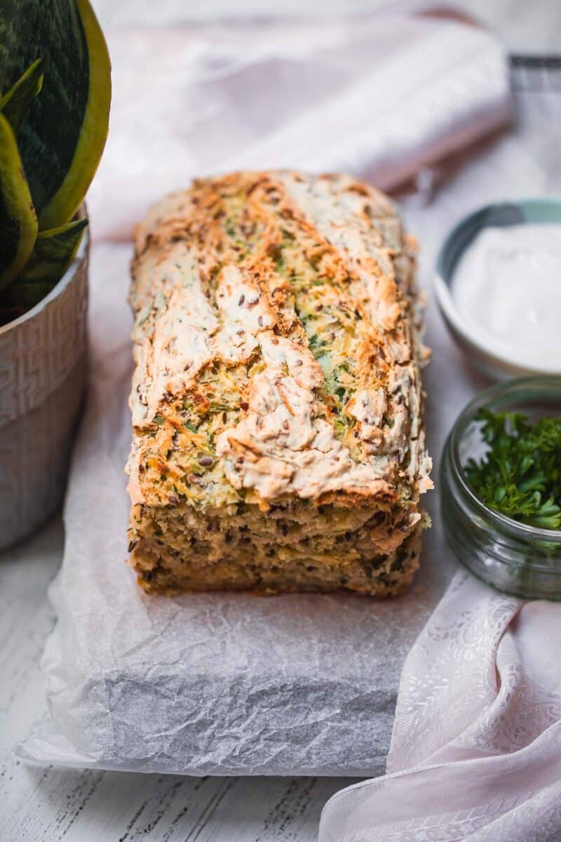 Vegan bread loaf with zucchini on a cooling rack