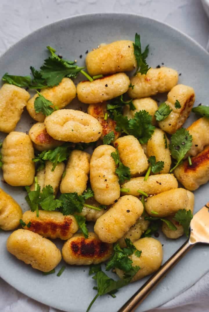 Gnocchi on a plate with olive oil and cilantro