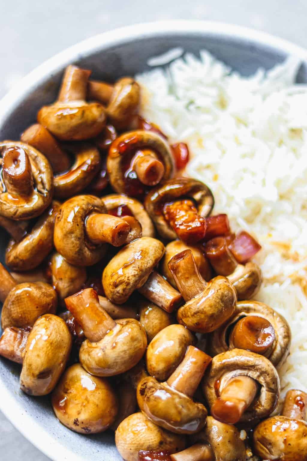 Glazed mushrooms and rice in a blue bowl