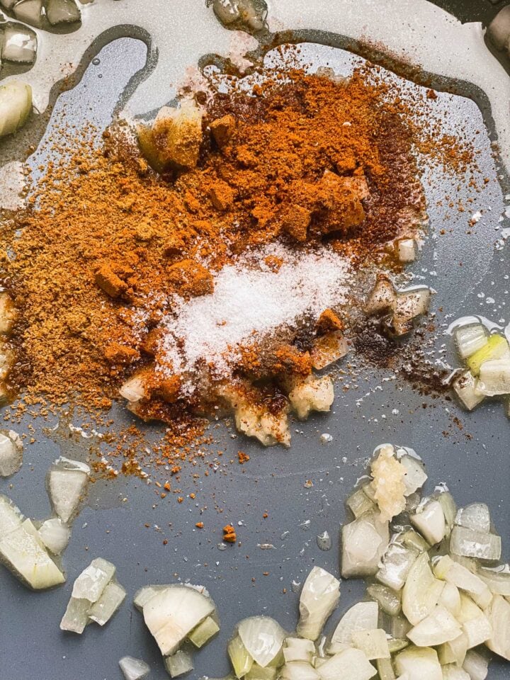Onion, garlic and spices in a frying pan