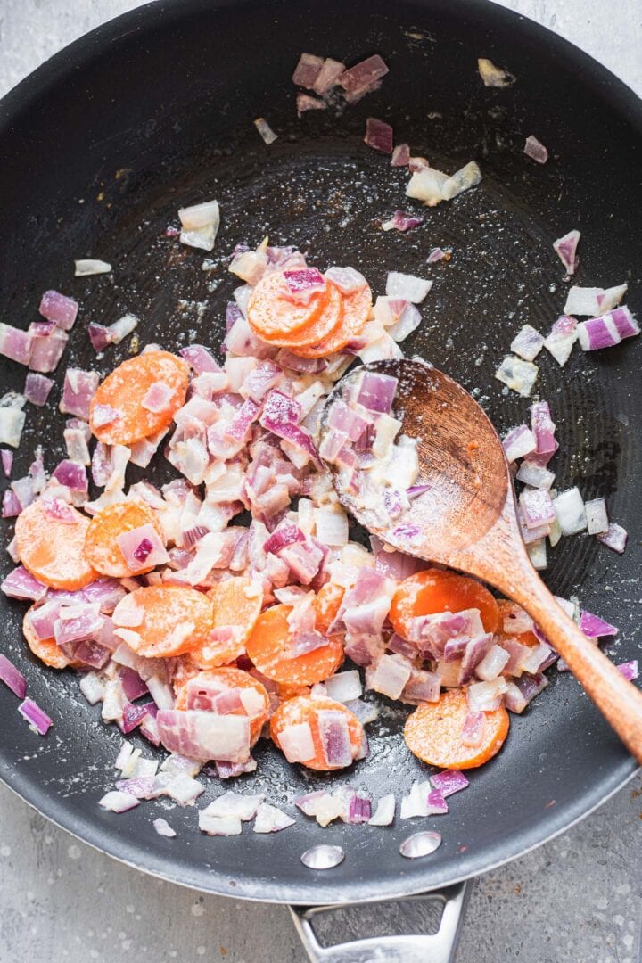 Onions and carrots in a frying pan