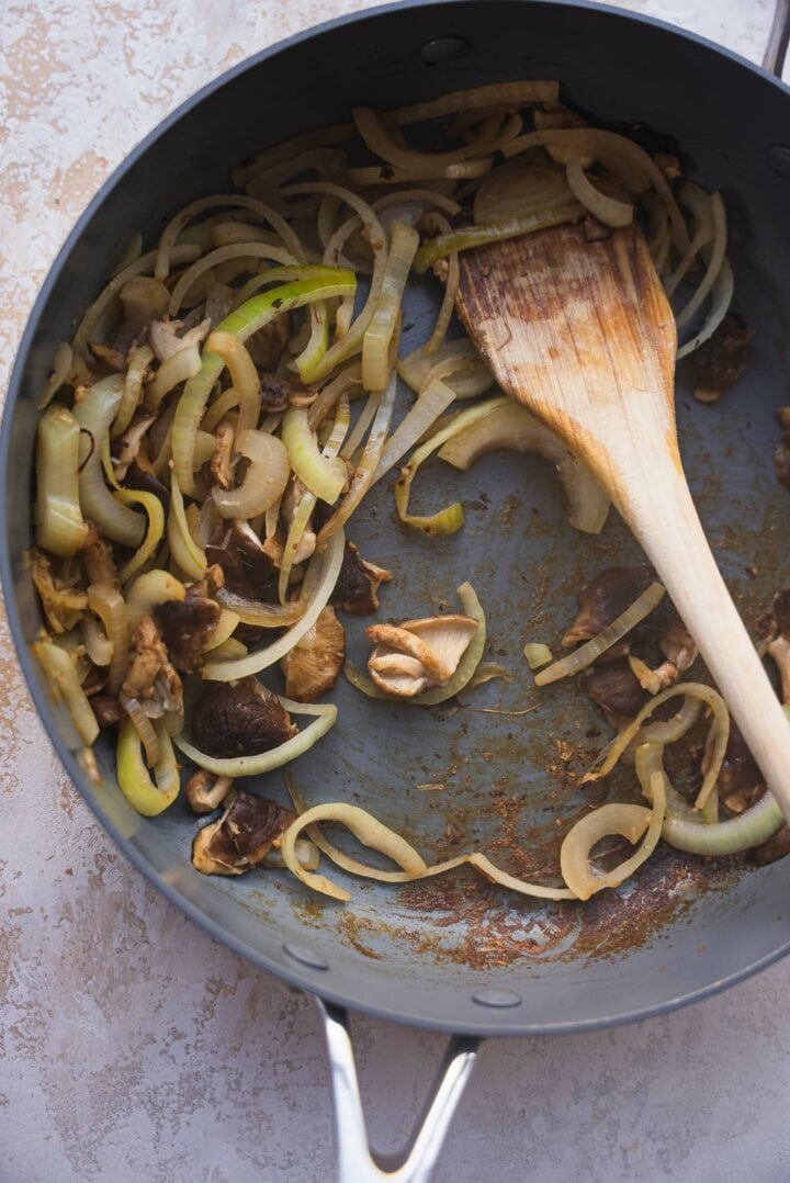 Onions and mushrooms in a frying pan