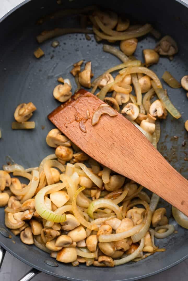 Onions and mushrooms in a frying pan