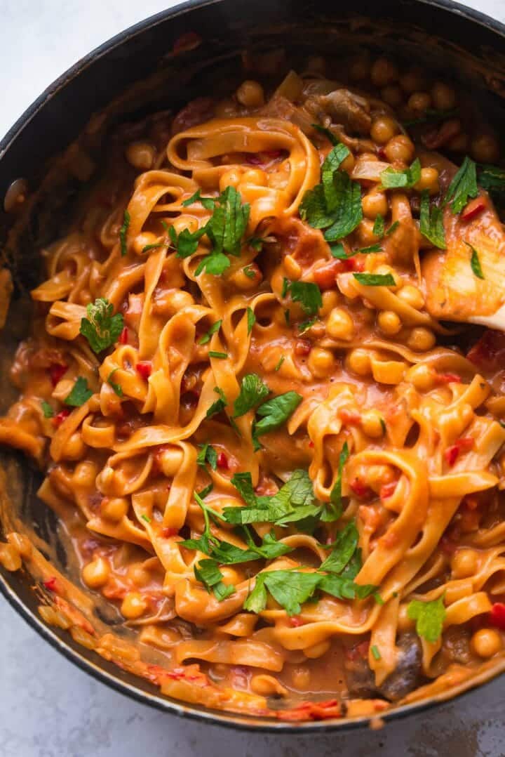 Pasta with chickpeas in a saucepan with coriander
