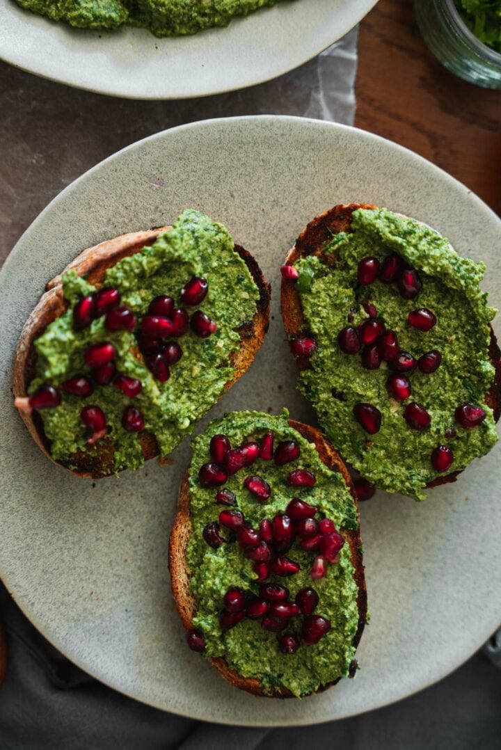 Pkhali and pomegranate seeds on toast