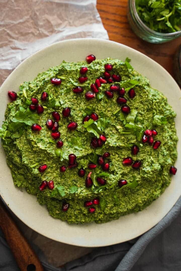 Plate of Georgian spinach spread with pomegranate seeds