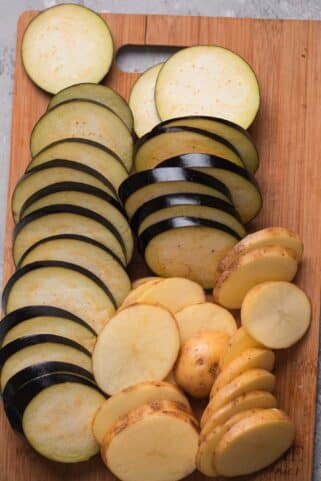 Potatoes and eggplant on a wooden board
