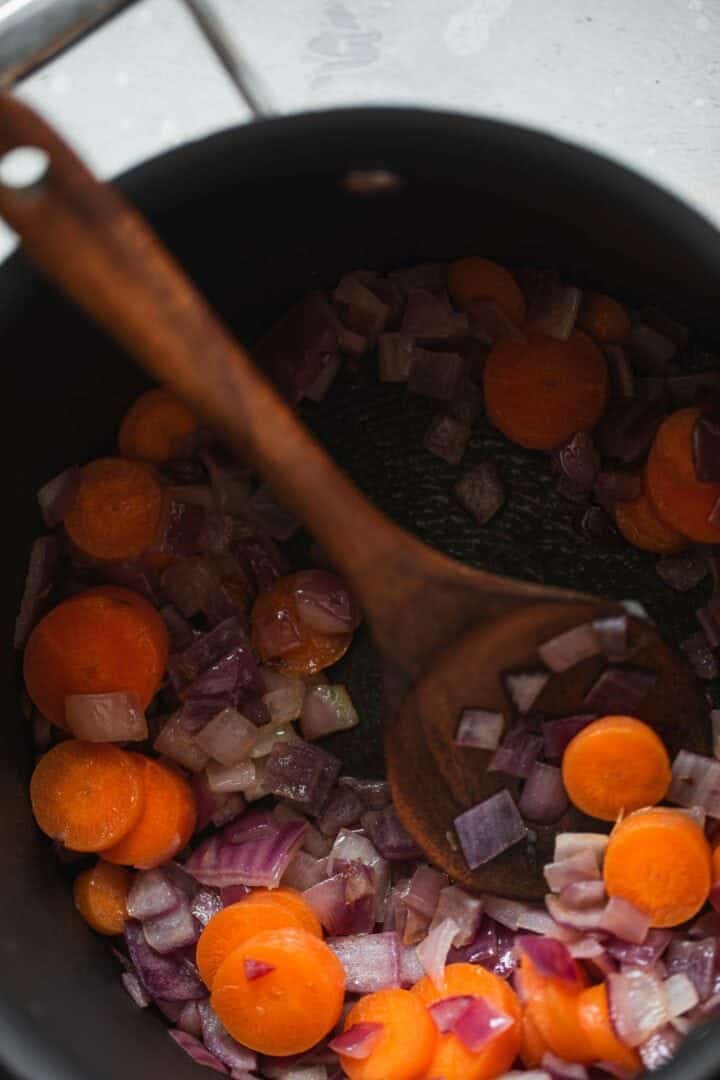 Red onion and carrots in a saucepan