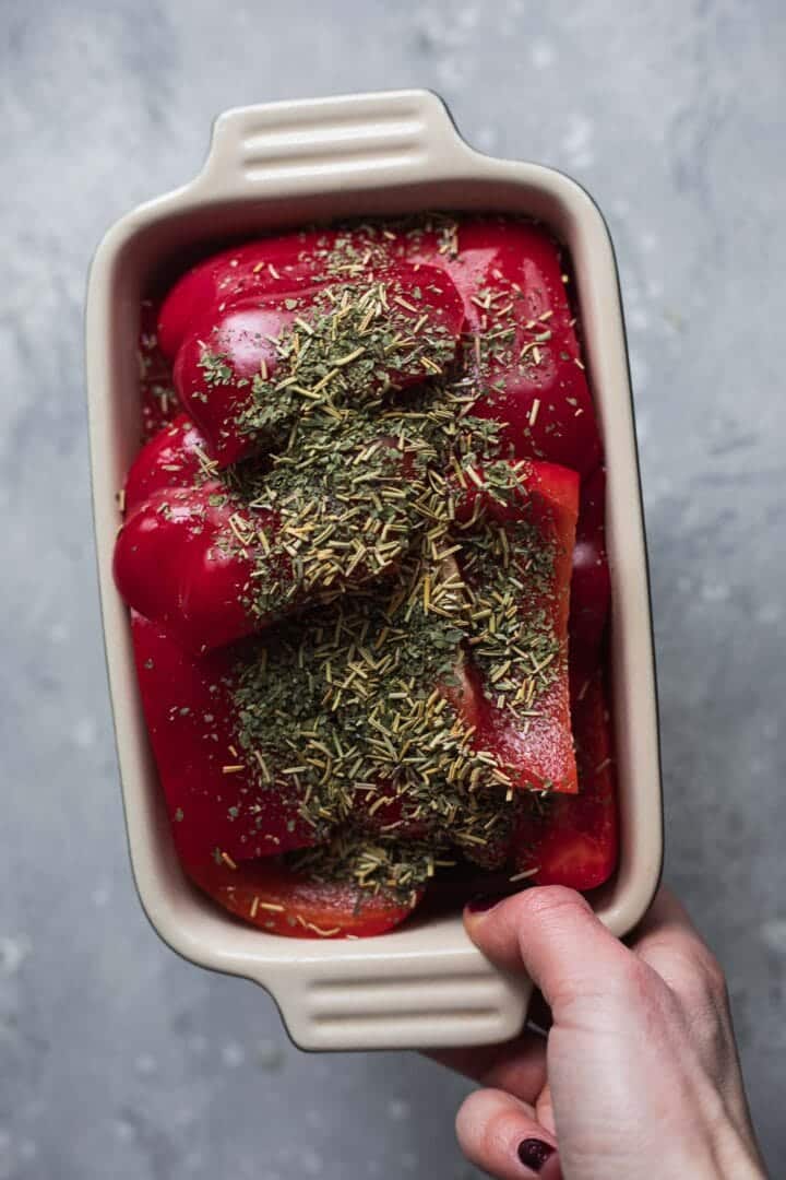 Red peppers and herbs in a baking dish