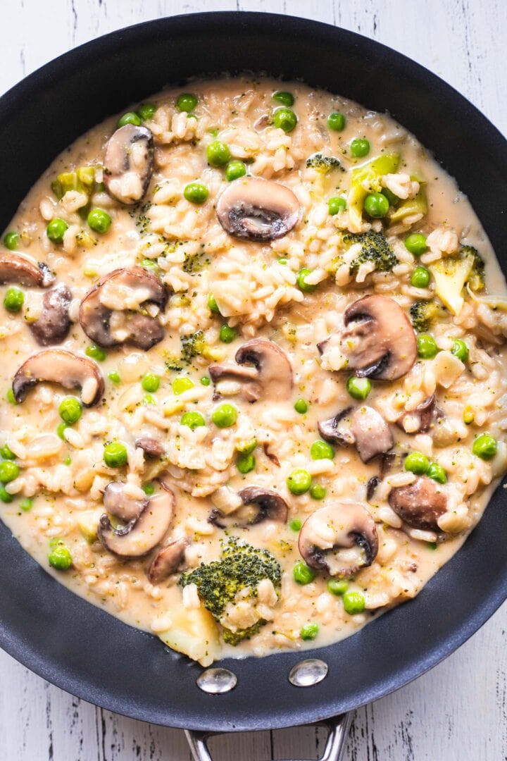 Risotto with broccoli and mushrooms in a pan