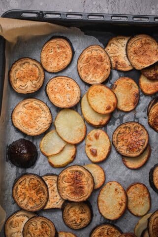 Roasted potatoes and aubergines on a baking tray