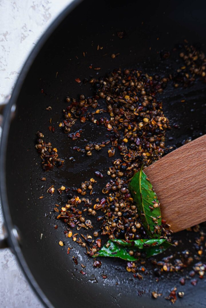 Spices and bay leaves in a frying pan