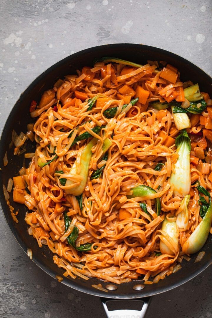 Spicy vegan noodles with Pak Choi in a frying pan