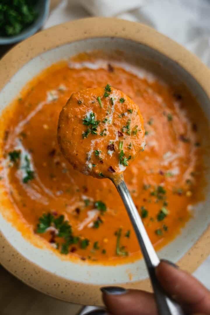 Spoon holding tomato soup