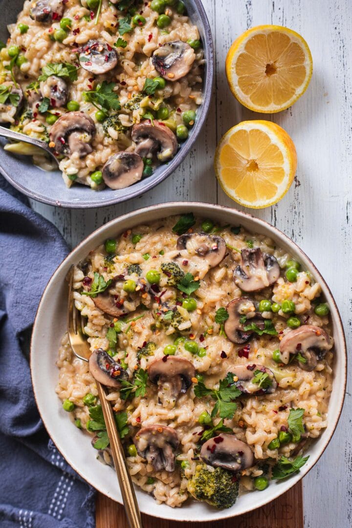 Two bowls of dairy-free risotto with mushrooms and broccoli