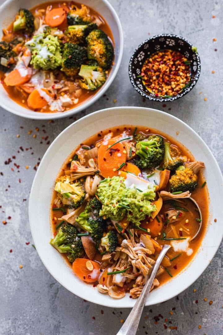 Two bowls of soup with jackfruit, sweet potato and broccoli